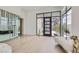 Bright foyer with sleek hardwood floors, floor-to-ceiling windows, and modern decor at 678 Blackrock Rim Dr, Henderson, NV 89012