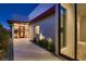 Contemporary home at twilight showcasing a bright front door and landscaped entrance at 678 Blackrock Rim Dr, Henderson, NV 89012