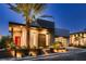 Modern home at dusk featuring desert landscaping and a unique privacy screen at 678 Blackrock Rim Dr, Henderson, NV 89012