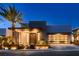 Contemporary home with desert landscaping, modern architecture, and a glass garage door at 678 Blackrock Rim Dr, Henderson, NV 89012