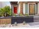 Modern front yard with a red door, desert landscaping, and a modern privacy screen at 678 Blackrock Rim Dr, Henderson, NV 89012