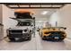 Garage featuring a multi-car setup with a lift, displaying high-end vehicles in an organized and well-lit area at 678 Blackrock Rim Dr, Henderson, NV 89012