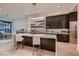 Bright, open kitchen with a breakfast bar island, modern lighting, and adjacent dining area at 678 Blackrock Rim Dr, Henderson, NV 89012