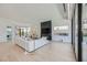 Spacious living room with a sleek fireplace, hardwood floors, and a wall of windows at 678 Blackrock Rim Dr, Henderson, NV 89012