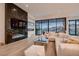 Modern living room featuring a marble fireplace, plush seating, and stunning views from large windows at 678 Blackrock Rim Dr, Henderson, NV 89012