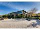 Modern playground area with sandy ground, exercise bars and tire obstacles near a building at 678 Blackrock Rim Dr, Henderson, NV 89012