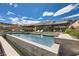 Beautiful backyard pool with lounge chairs and sleek modern architecture at 678 Blackrock Rim Dr, Henderson, NV 89012