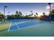 Well-maintained tennis court with surrounding palm trees and clear skies, offering an excellent recreational amenity at 678 Blackrock Rim Dr, Henderson, NV 89012