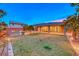 Large backyard featuring a green lawn, patio, and a fire pit at 7106 Stanley Frederick St, Las Vegas, NV 89166