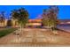 Stone pathway leads to a stylish outdoor fire pit and seating area with lush landscaping around the backyard at 7106 Stanley Frederick St, Las Vegas, NV 89166