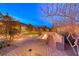 Inviting backyard featuring a stone fire pit with built-in seating, perfect for entertaining guests at 7106 Stanley Frederick St, Las Vegas, NV 89166