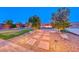 Backyard landscape includes a gas fire pit and stone walking path at 7106 Stanley Frederick St, Las Vegas, NV 89166