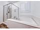 Bathroom featuring white soaking tub with chrome fixtures, a separate shower, and a window with white shutters at 7106 Stanley Frederick St, Las Vegas, NV 89166