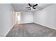 Spacious, empty bedroom with neutral carpet, a ceiling fan, and a hallway entrance at 7106 Stanley Frederick St, Las Vegas, NV 89166