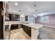 Well-appointed kitchen with granite counters, dark cabinets, stainless appliances, and pendant lights at 7106 Stanley Frederick St, Las Vegas, NV 89166