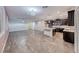 An open-concept living space featuring tile flooring, a chandelier, and seamlessly connected kitchen at 7106 Stanley Frederick St, Las Vegas, NV 89166