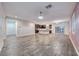 Open concept living space with wood-look tile, chandelier and connection to the kitchen at 7106 Stanley Frederick St, Las Vegas, NV 89166