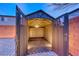 A spacious backyard shed with a brick floor, metal walls, and open doors providing ample storage at 7106 Stanley Frederick St, Las Vegas, NV 89166