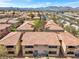 Community view with consistently styled buildings near a highway and mountain range backdrop at 7300 Pirates Cove Rd # 1062, Las Vegas, NV 89145