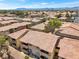 Aerial view showcases the community layout with multiple buildings and mountain backdrop at 7300 Pirates Cove Rd # 1062, Las Vegas, NV 89145