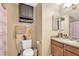 Cozy bathroom featuring a wood vanity, coordinated towel set, and ample storage cabinet at 7300 Pirates Cove Rd # 1062, Las Vegas, NV 89145