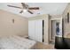 Bedroom features ceiling fan, double closet and view of the bathroom at 7300 Pirates Cove Rd # 1062, Las Vegas, NV 89145