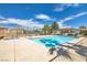 Community pool with clear blue water, surrounded by a secure fence and greenery at 7300 Pirates Cove Rd # 1062, Las Vegas, NV 89145