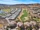 Scenic aerial view of real estate showcasing houses near a golf course with mountains as backdrop at 75 Luce Del Sole # 3, Henderson, NV 89011