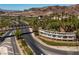 Aerial view of Lake Las Vegas entrance sign, landscaped surroundings, and winding roads at 75 Luce Del Sole # 3, Henderson, NV 89011