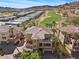 Aerial view of homes, golf course, and scenic mountain landscape, showcasing community at 75 Luce Del Sole # 3, Henderson, NV 89011