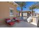 Relaxing balcony area with lounge chairs, wicker furniture, and palm trees offering a serene outdoor space at 75 Luce Del Sole # 3, Henderson, NV 89011