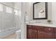 Bathroom featuring tiled shower over tub and dark wood vanity at 75 Luce Del Sole # 3, Henderson, NV 89011