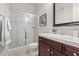 Bathroom features a glass-enclosed shower, dark wood vanity with sink, and neutral tile flooring at 75 Luce Del Sole # 3, Henderson, NV 89011