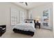 Bedroom with dark wood bed frame, white bedding, and natural light from three windows at 75 Luce Del Sole # 3, Henderson, NV 89011