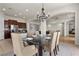 Bright dining room featuring a modern chandelier, stylish table setting, and easy access to the kitchen at 75 Luce Del Sole # 3, Henderson, NV 89011