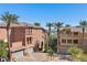 Exterior view showcasing contemporary architecture, manicured landscaping, and community lake at 75 Luce Del Sole # 3, Henderson, NV 89011