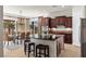 Modern kitchen featuring an island, breakfast bar, and dark wood cabinetry with backyard views at 75 Luce Del Sole # 3, Henderson, NV 89011