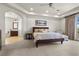 Bright main bedroom featuring neutral tones, a ceiling fan, and an ensuite bathroom with a soaking tub at 75 Luce Del Sole # 3, Henderson, NV 89011