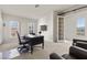 A home office provides a functional workspace with natural light from the windows at 75 Luce Del Sole # 3, Henderson, NV 89011