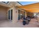 Covered patio featuring comfortable seating, a textured floor, and multiple sliding glass doors at 75 Luce Del Sole # 3, Henderson, NV 89011