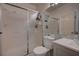 Neutral bathroom featuring a glass shower, a white toilet, and a modern vanity with a large mirror at 7650 Hartwell Dr, Las Vegas, NV 89123