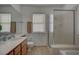 Well-lit bathroom featuring shower with tiled accents and updated fixtures at 7650 Hartwell Dr, Las Vegas, NV 89123