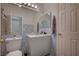 Cozy bathroom with decorative tile accent, modern vanity, and neutral walls at 7650 Hartwell Dr, Las Vegas, NV 89123