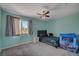 Cozy bedroom with natural light, gray curtains, and a ceiling fan for a restful ambiance at 7650 Hartwell Dr, Las Vegas, NV 89123