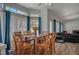 Bright dining area featuring a wooden table with seating for six, and large window views at 7650 Hartwell Dr, Las Vegas, NV 89123