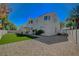 Back exterior view of two-story home with covered patio and artificial turf at 7650 Hartwell Dr, Las Vegas, NV 89123