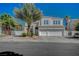 Charming two-story home featuring desert landscaping and a three-car garage at 7650 Hartwell Dr, Las Vegas, NV 89123