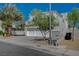 Two-story home featuring desert landscaping, a three-car garage, and a street view at 7650 Hartwell Dr, Las Vegas, NV 89123