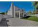 Back exterior view of two-story home with covered patio and artificial turf at 7650 Hartwell Dr, Las Vegas, NV 89123