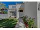 Inviting front entrance of a two-story home, with a manicured lawn and desert landscaping at 7650 Hartwell Dr, Las Vegas, NV 89123